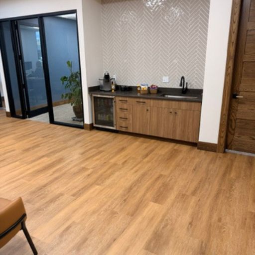 wood look floors near conference room with hallway cabinets and sink
